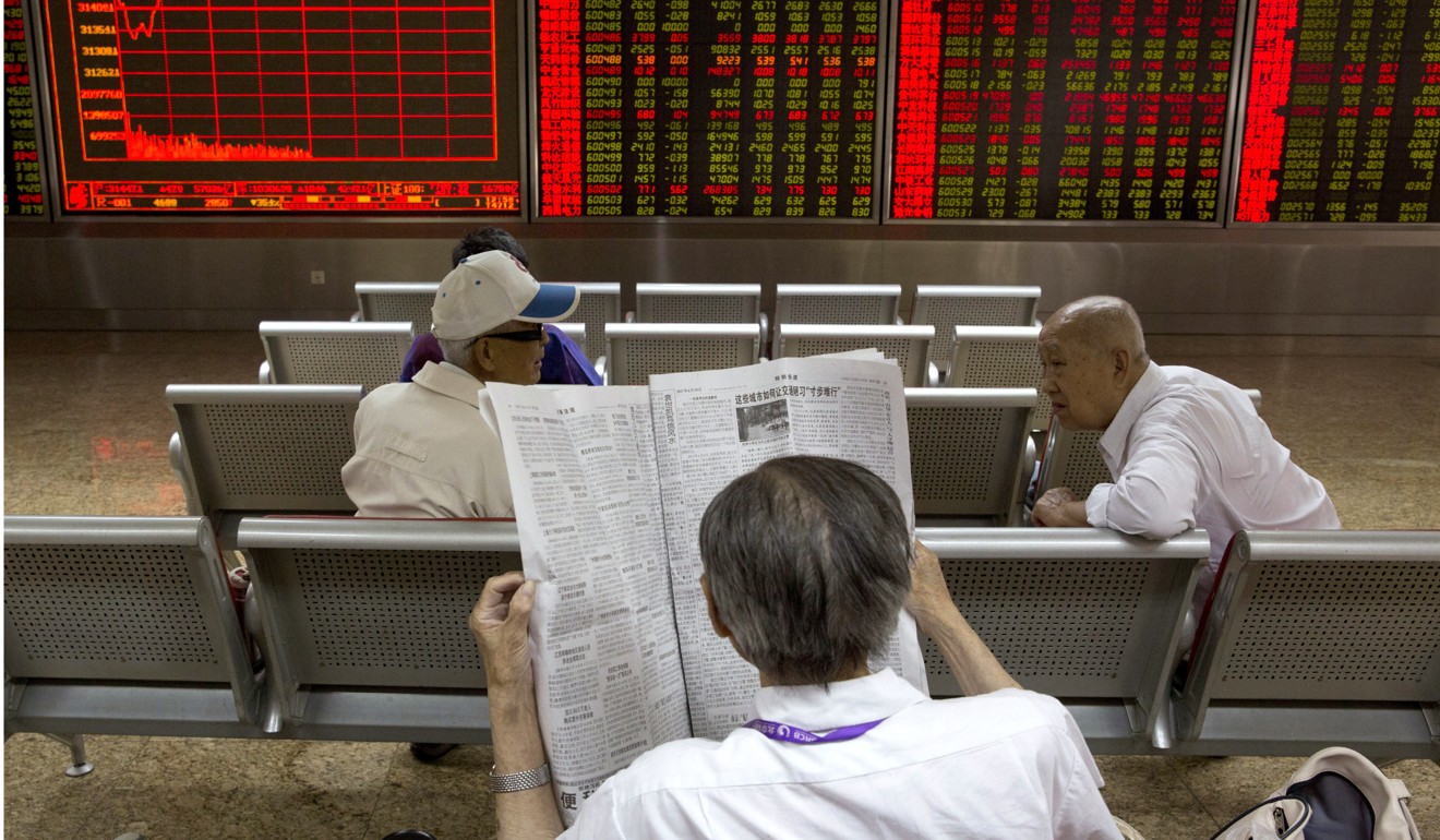Investors wait for the start of the afternoon trading at a brokerage in Beijing, China. Photo: AP