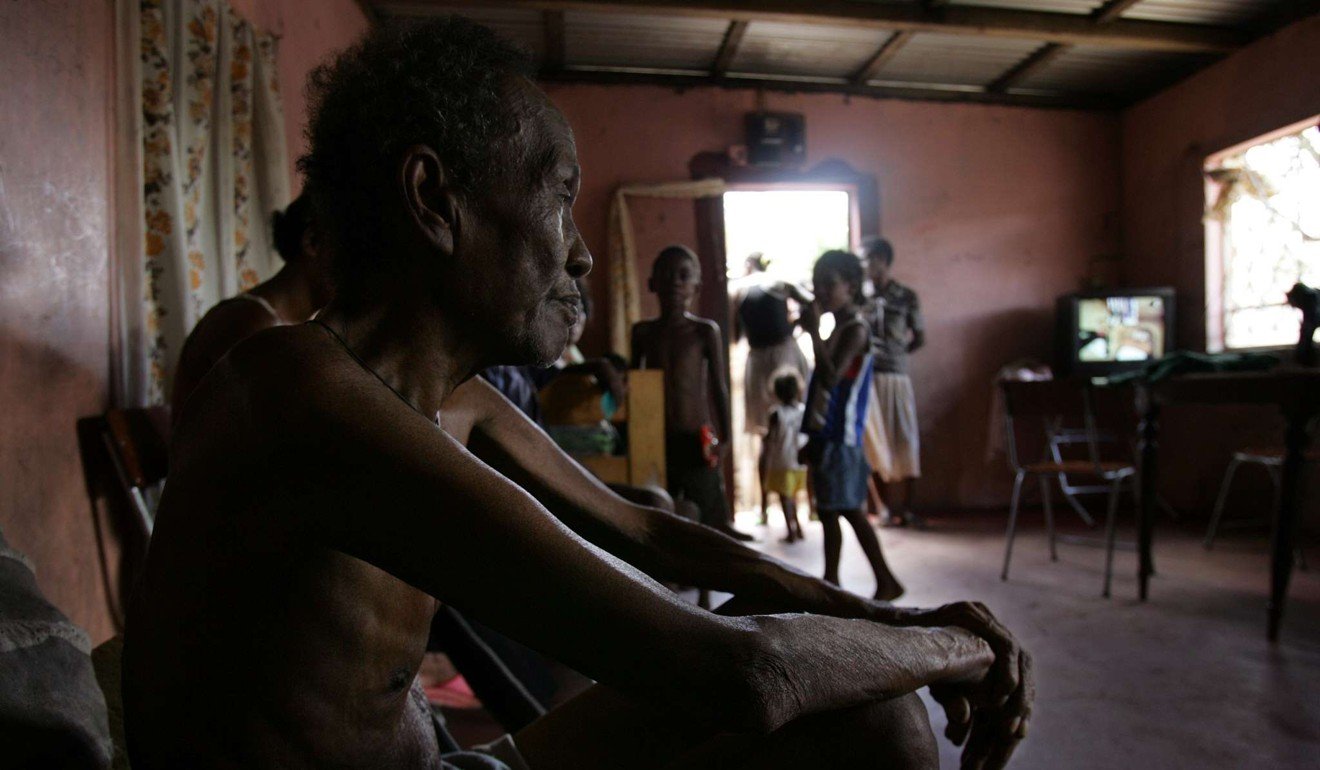 Louis Onesime sits in the house he shares with 26 other family members in Port Louis, Mauritius, despite being originally from the Chagos Archipelago and being forcibly removed. Photo: AFP