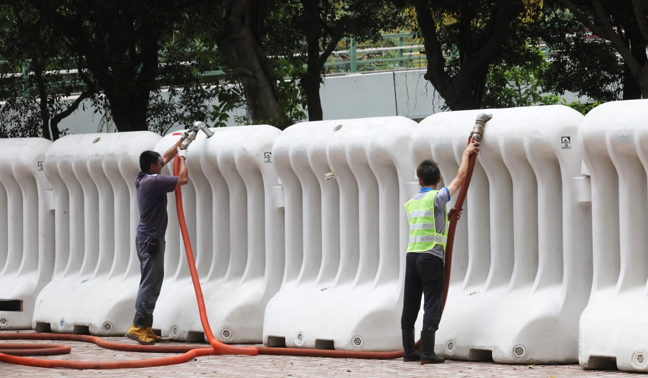 When filled with water, the barriers weigh about two tonnes each. Photo: Felix Wong