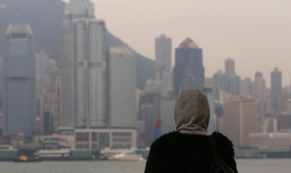 Pedestrians wear thick clothes under cold weather in Tsim Sha Tsui. Photo: Dickson Lee