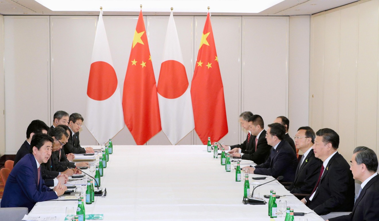 Japanese Prime Minister Shinzo Abe (left) and Chinese President Xi Jinping (second from right) during their half-hour meeting on the sidelines of the G20 summit in Hamburg, Germany. Photo: Kyodo