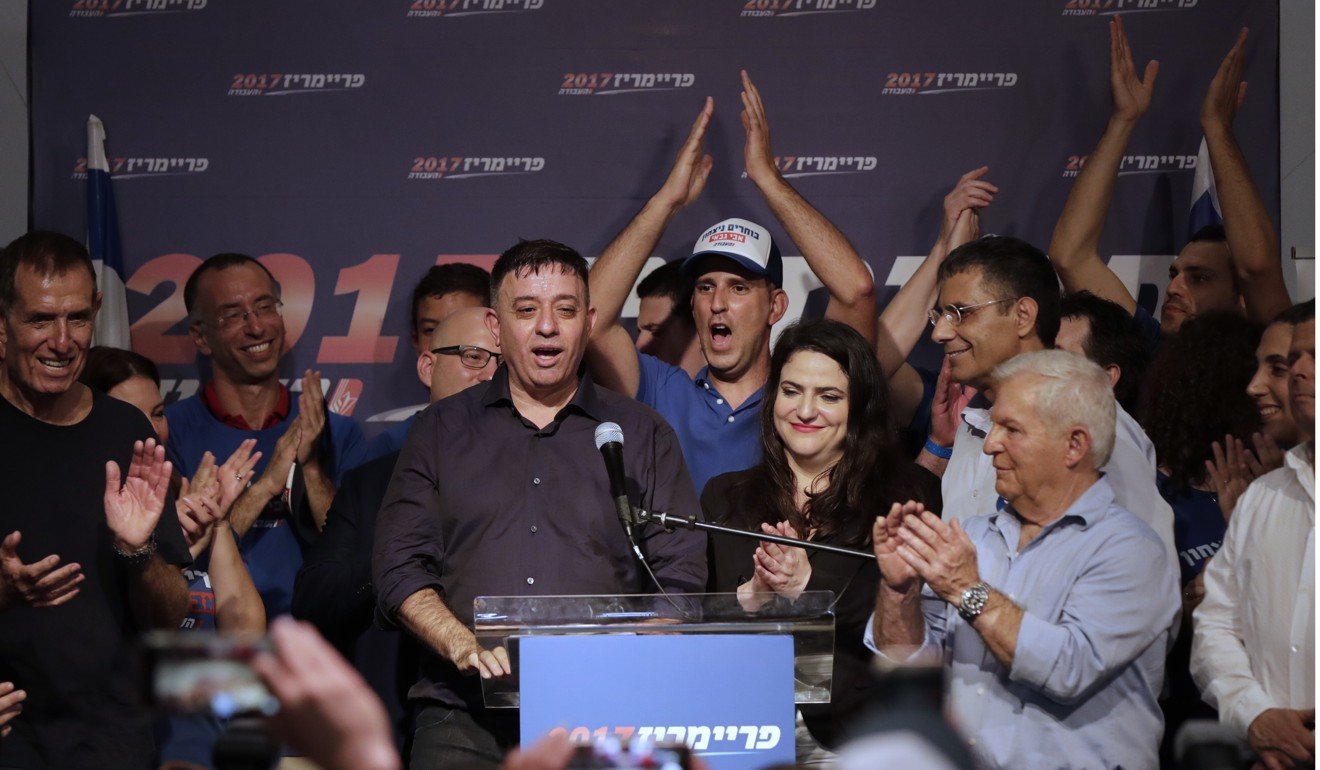 Avi Gabbay, centre, stands with supporters after his victory in Tel Avi. Photo: AP