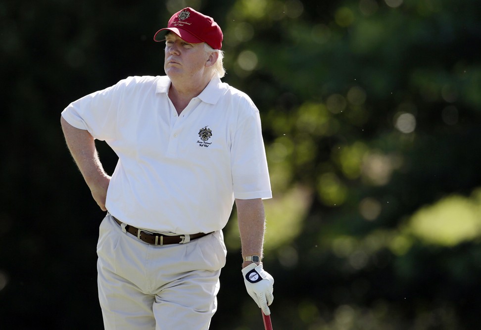 Donald Trump stands on the fairway during a pro-am round of the AT&T National golf tournament at Congressional Country Club in 2012. Photo: AP