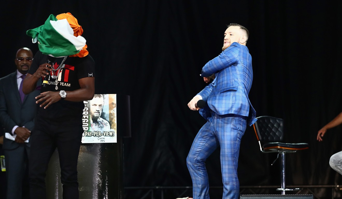 Conor McGregor throws an Irish flag at Floyd Mayweather. Photo: USA TODAY Sports