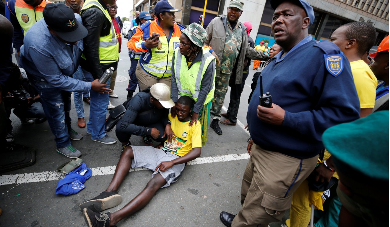 An injured supporter of South Africa's President Jacob Zuma reacts after rubber bullets were fired by police in Johannesburg. Photo: Reuters