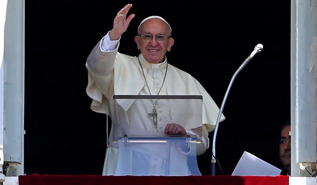 Pope Francis waves as he leads the Angelus prayer in Saint Peter's Square at the Vatican. Photo: Reuters