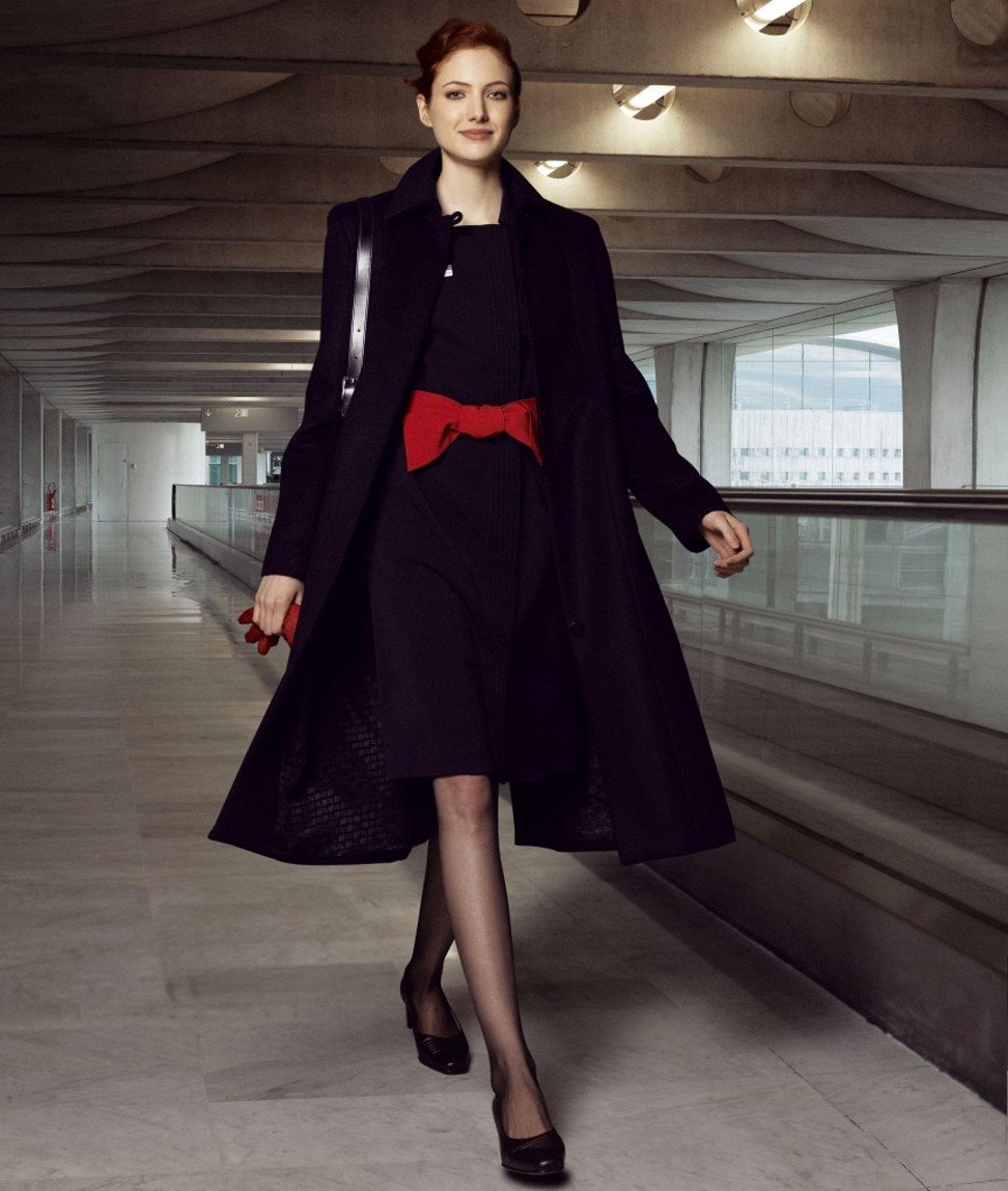 Air France uniform with signature red gloves and bright red bow-tie belt.