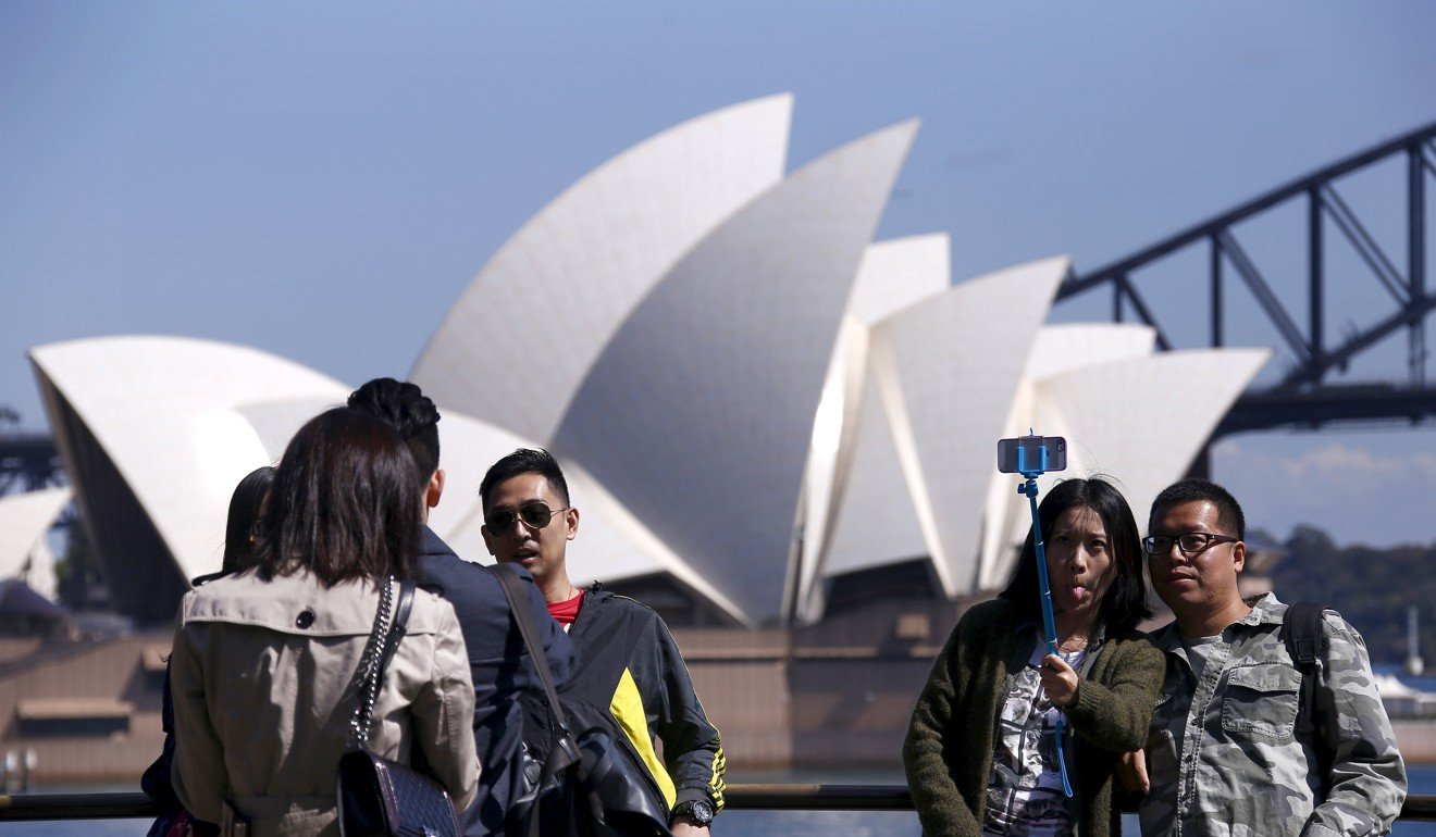 Chinese tourists taking selfies in front of Sydney Opera House. Photo: Reuters