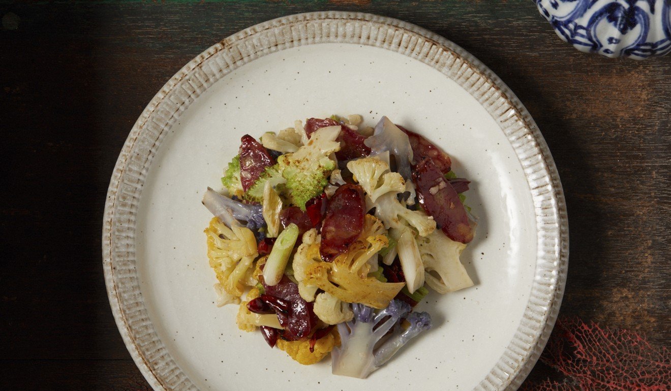 Wok-fried purple and yellow cauliflower with Szechuan cured sausage.