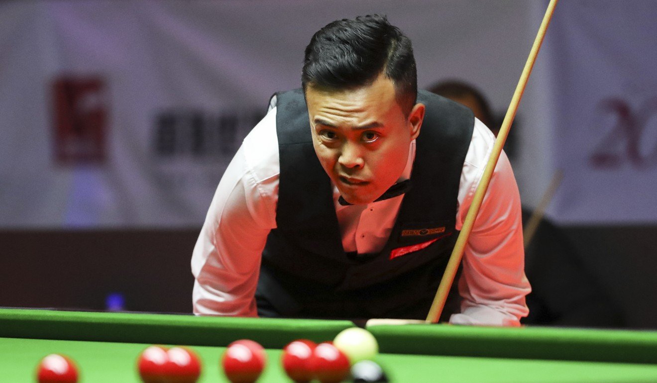Marco Fu checks out his potting opportunities against Barry Hawkins.