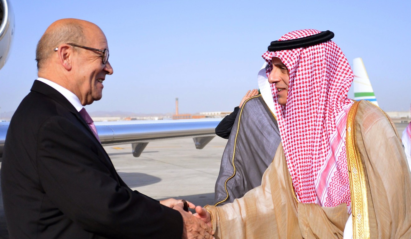 A handout photo made available by the Saudi Press Agency showing French Foreign Minister Jean-Yves Le Drian (L) and Saudi Foreign Minister Adel al-Jubeir (R) shaking hands on the French foreign minister's arrival in Jeddah, Saudi Arabia. The Saudis have led other countries in the Gulf in a blockade against Qatar. Photo: Saudi Press Agencey via EPA