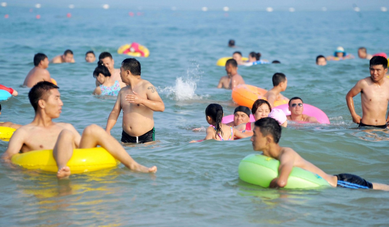 People take a dip in the sea at Qingdao, Shandong province. Photo: AFP