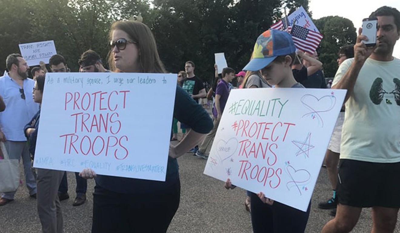 Dozens of people gathered in front of the White House Wednesday night as part of a last-minute protest over President Trump's announcement that he would ban transgender people from serving in the military. Photo: The Washington Post