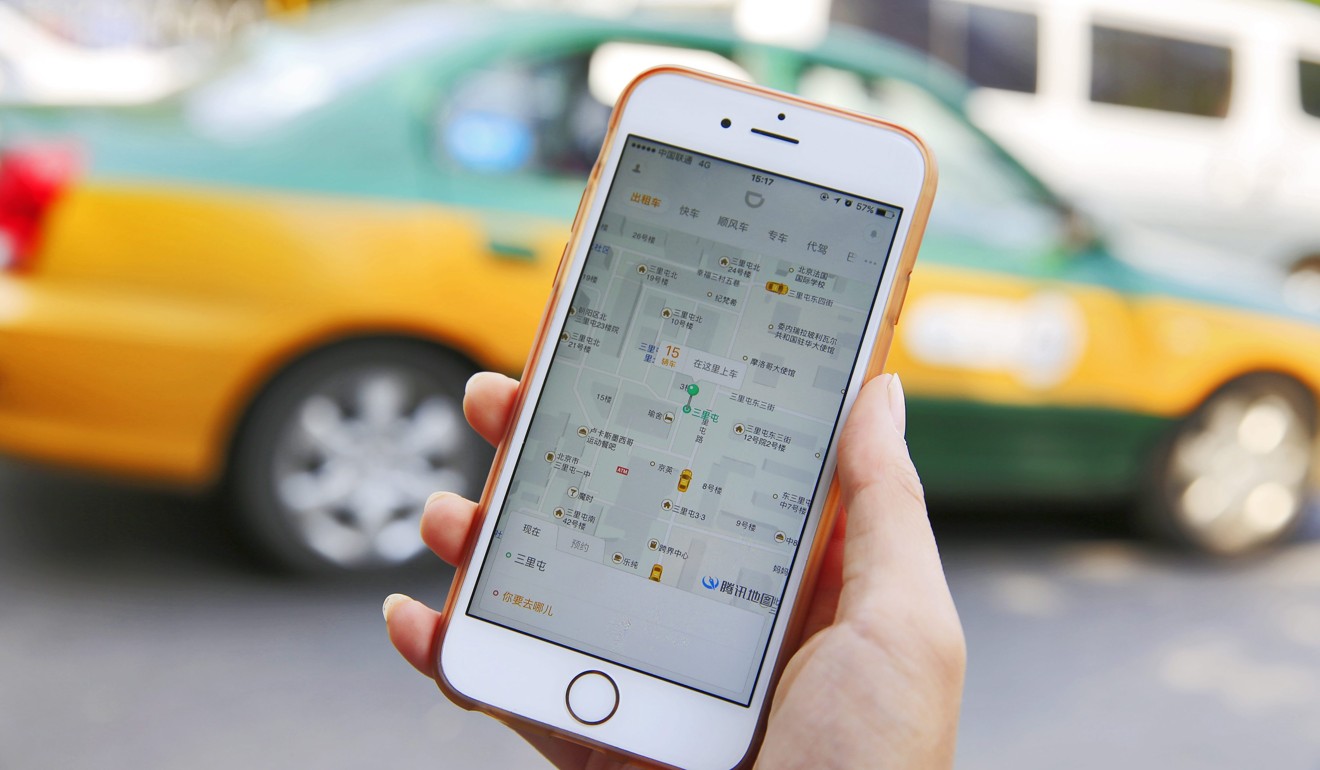 A commuter shows the Didi Chuxing app on her iPhone in Beijing, China. Singapore-based Grab announced that China’s ride-hail champion, along with SoftBank, will invest up to US$2 billion in the company. Photo: EPA