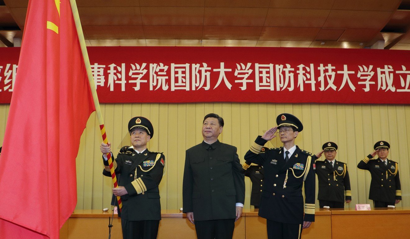 Chinese President Xi Jinping presents the heads of the National Defence University of the People's Liberation Army with the military flag in Beijing. Photo: Xinhua