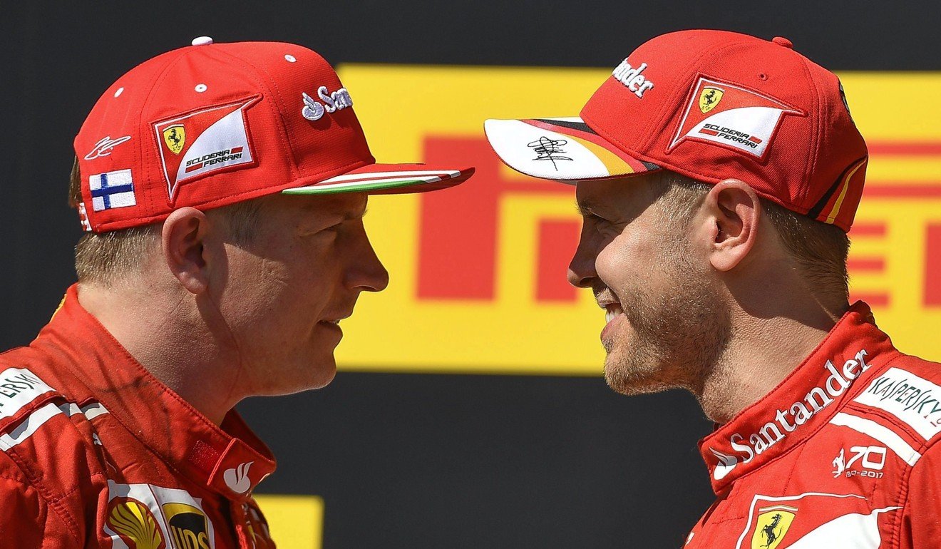 Ferrari’s Kimi Raikkonen and Sebastian Vettel stand face to face on the podium. Photo: AP