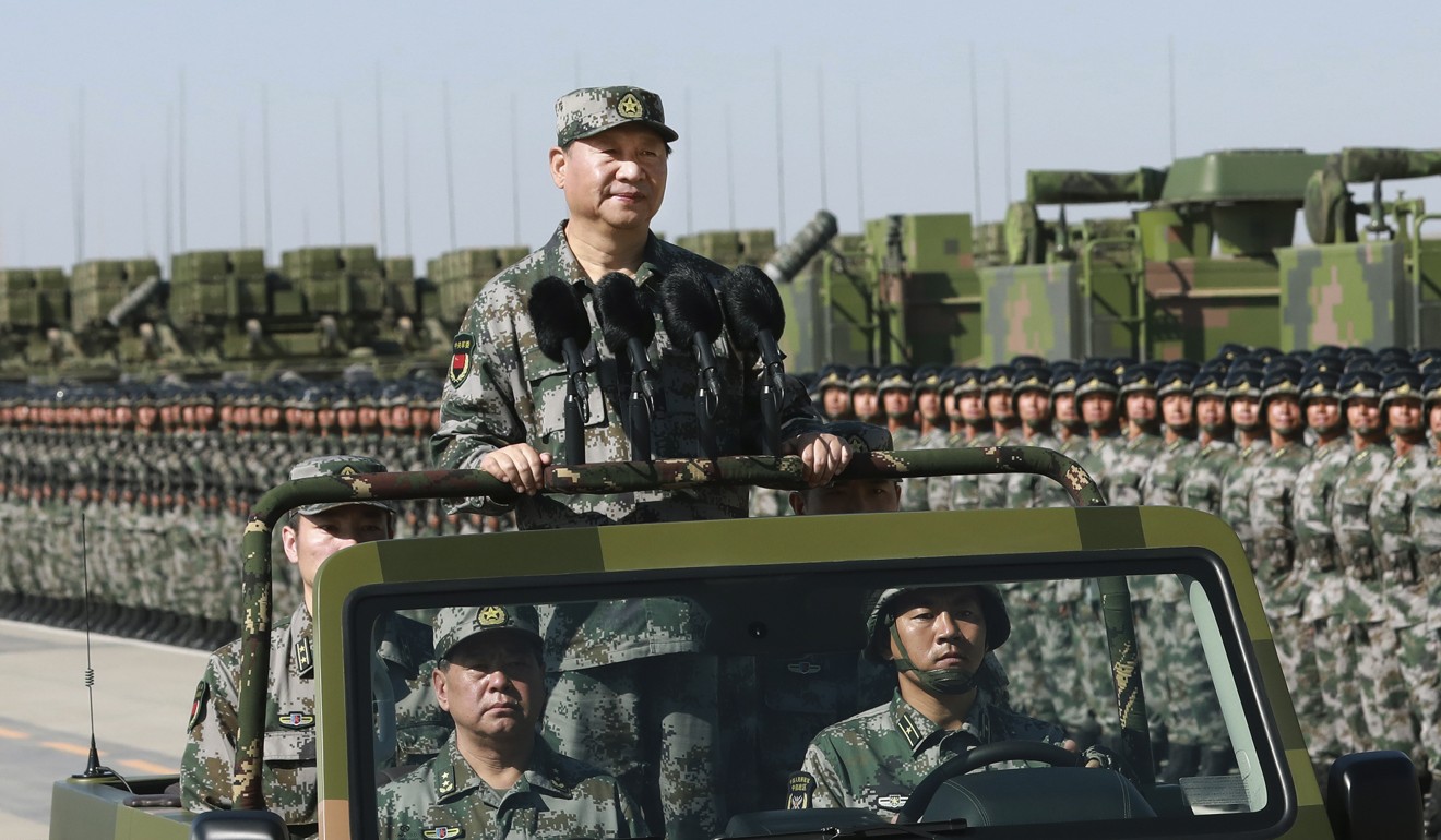 President Xi Jinping stands on a military jeep as he inspects troops of the People's Liberation Army during a military parade to commemorate the 90th anniversary of the founding of the PLA at Zhurihe training base in north China's Inner Mongolia Autonomous Region on Sunday. Photo: Xinhua via Associated Press
