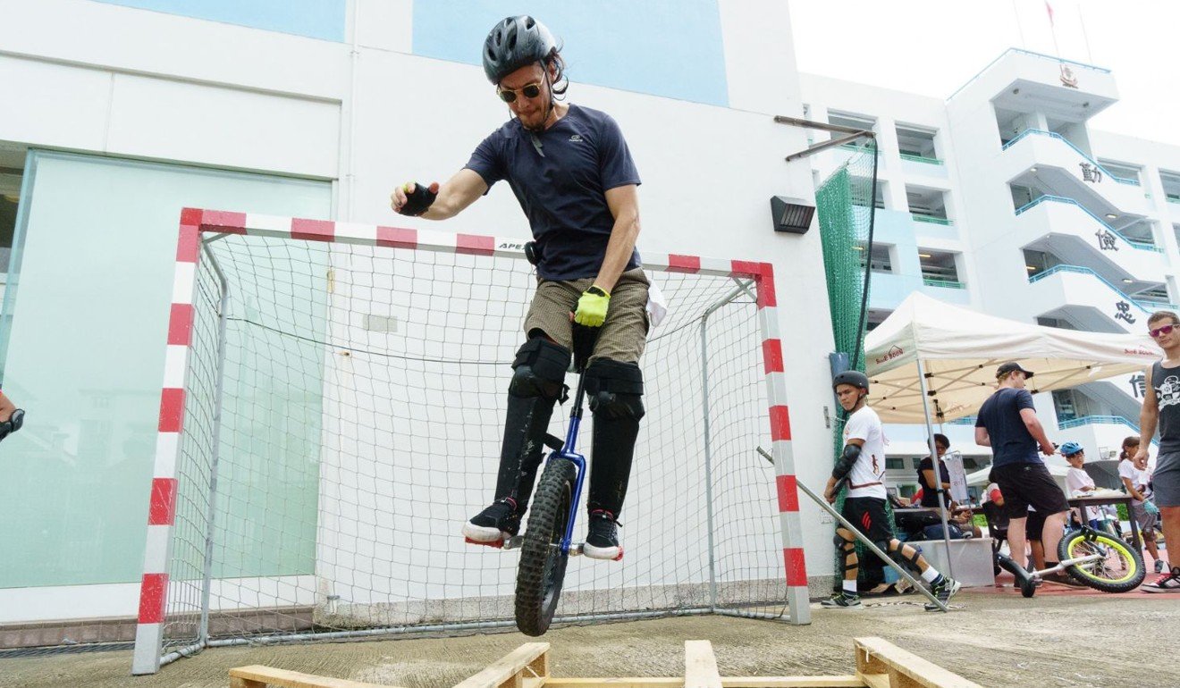 A unicyclist makes his way over an obstacle during the trials event.