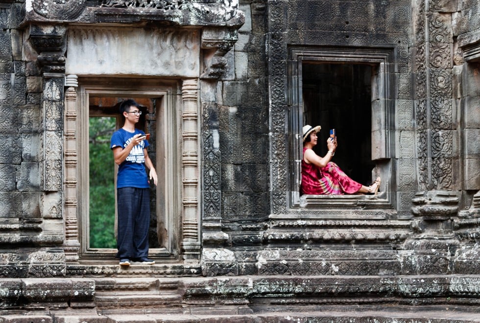 Chinese tourists at a Khmer temple in Angkor. Picture: Alamy