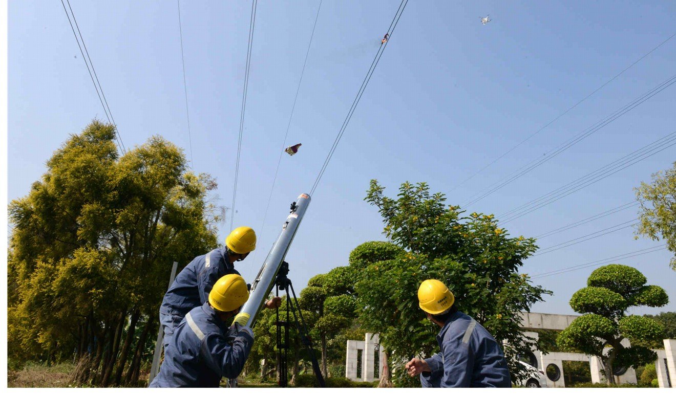 A Chinese power company use laser cannon to remove debris from a power line. Road and electricity sectors account for more than two-thirds of China’s future spending needs.Photo: SCMP Pictures