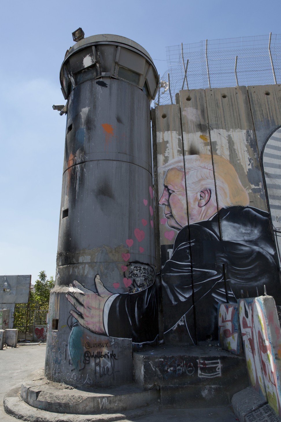 A mural resembling the work of elusive artist Banksy depicts US President Donald Trump kissing an Israeli army watchtower. Photo: AP