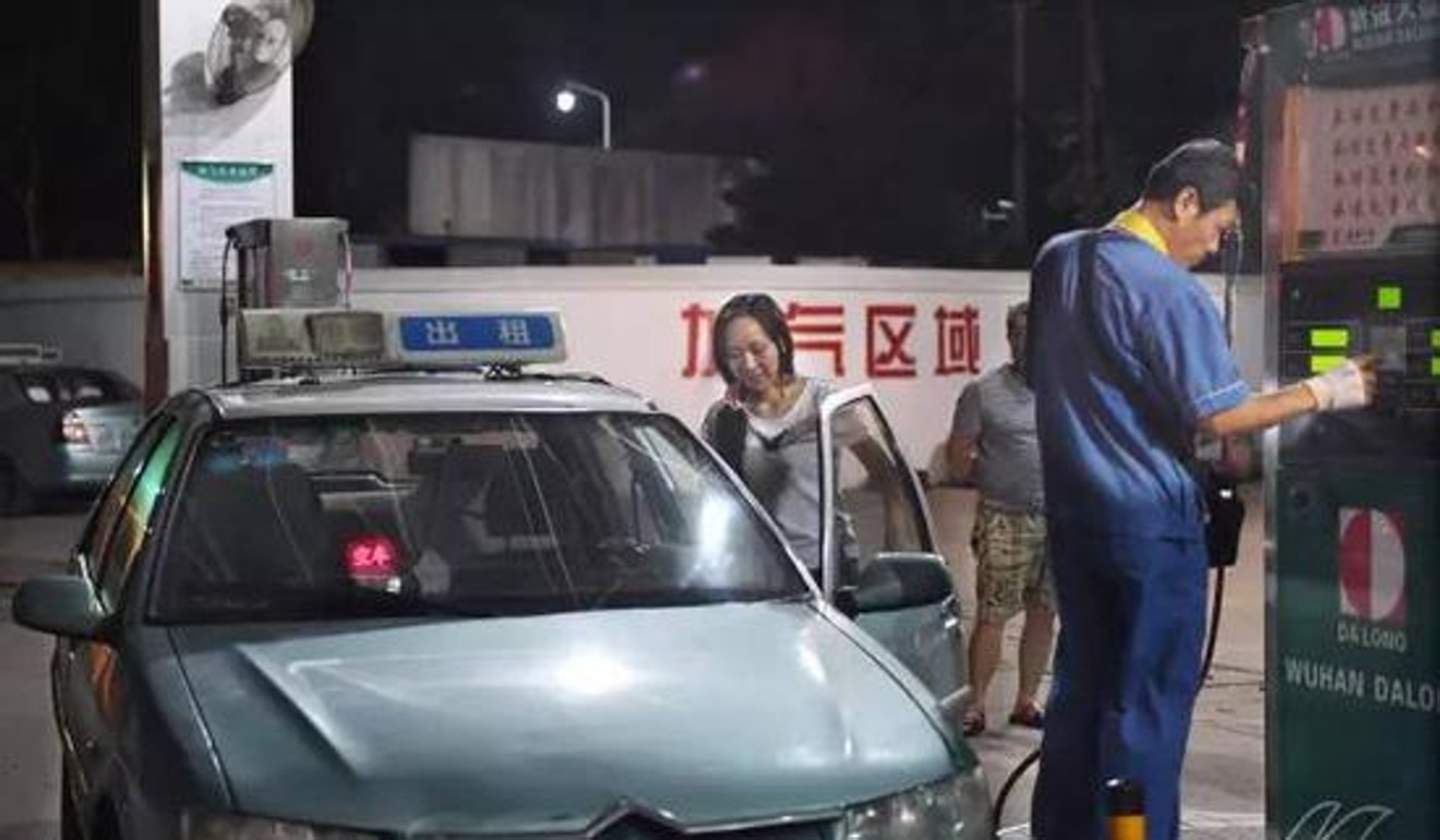 Li refuels the cab at a gas station. Photo: Handout