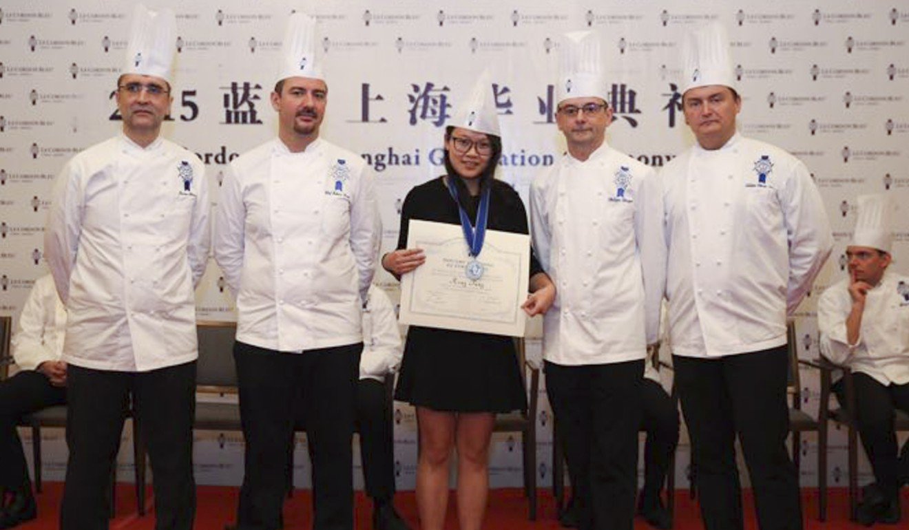 Tang (centre) with her instructors during her Grand Diplome medal and certificate ceremony.