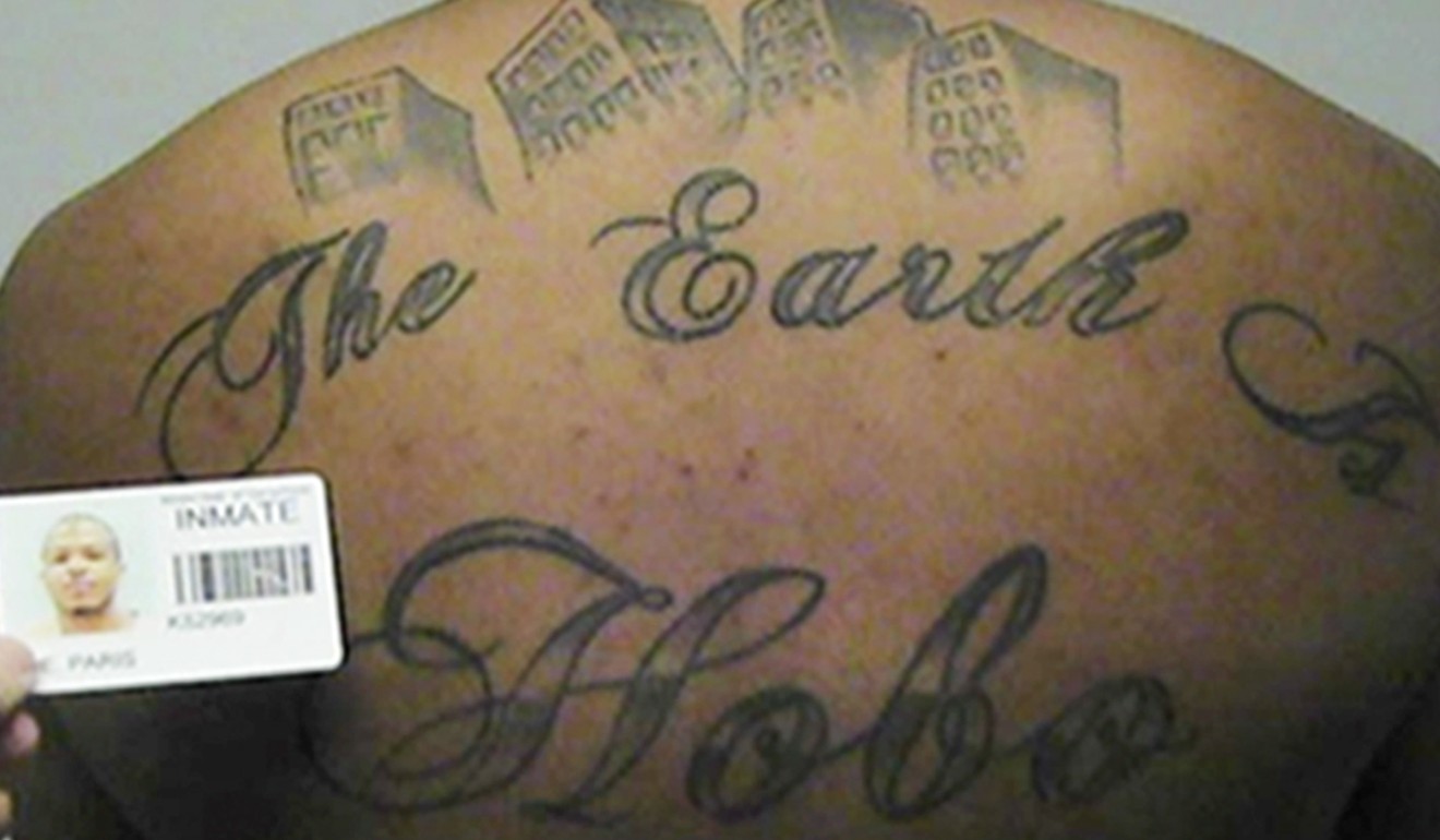 File photo in a court filing provided by the United States Attorney's office in Chicago shows Paris Poe's back tattoo that reads “The Earth Is Our Turf”, and “Hobo.” Photo: United States Attorney's office in Chicago via AP