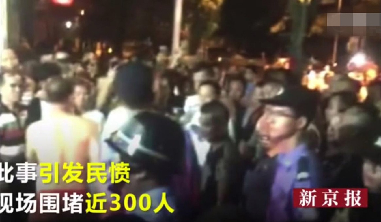 Crowds gathered outside the men’s homes. Photo: Handout