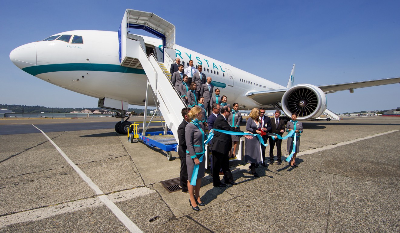 Edie Rodriguez, CEO of Crystal Cruises, center, cuts the ribbon of Crystal Cruises new VIP jetliner, a Boeing 777-200LR. Photo: TNS