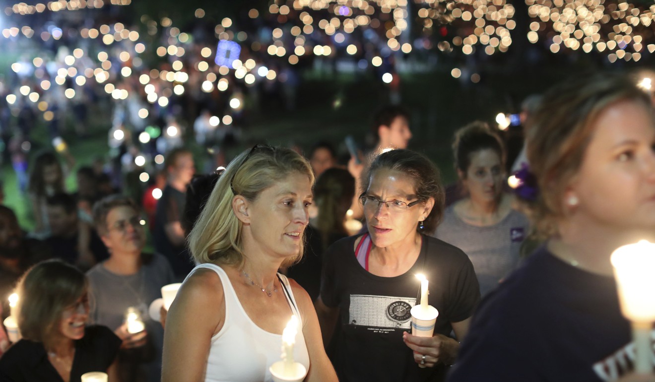 People participate in a candlelight vigil at the University of Virginia. Photo: AP