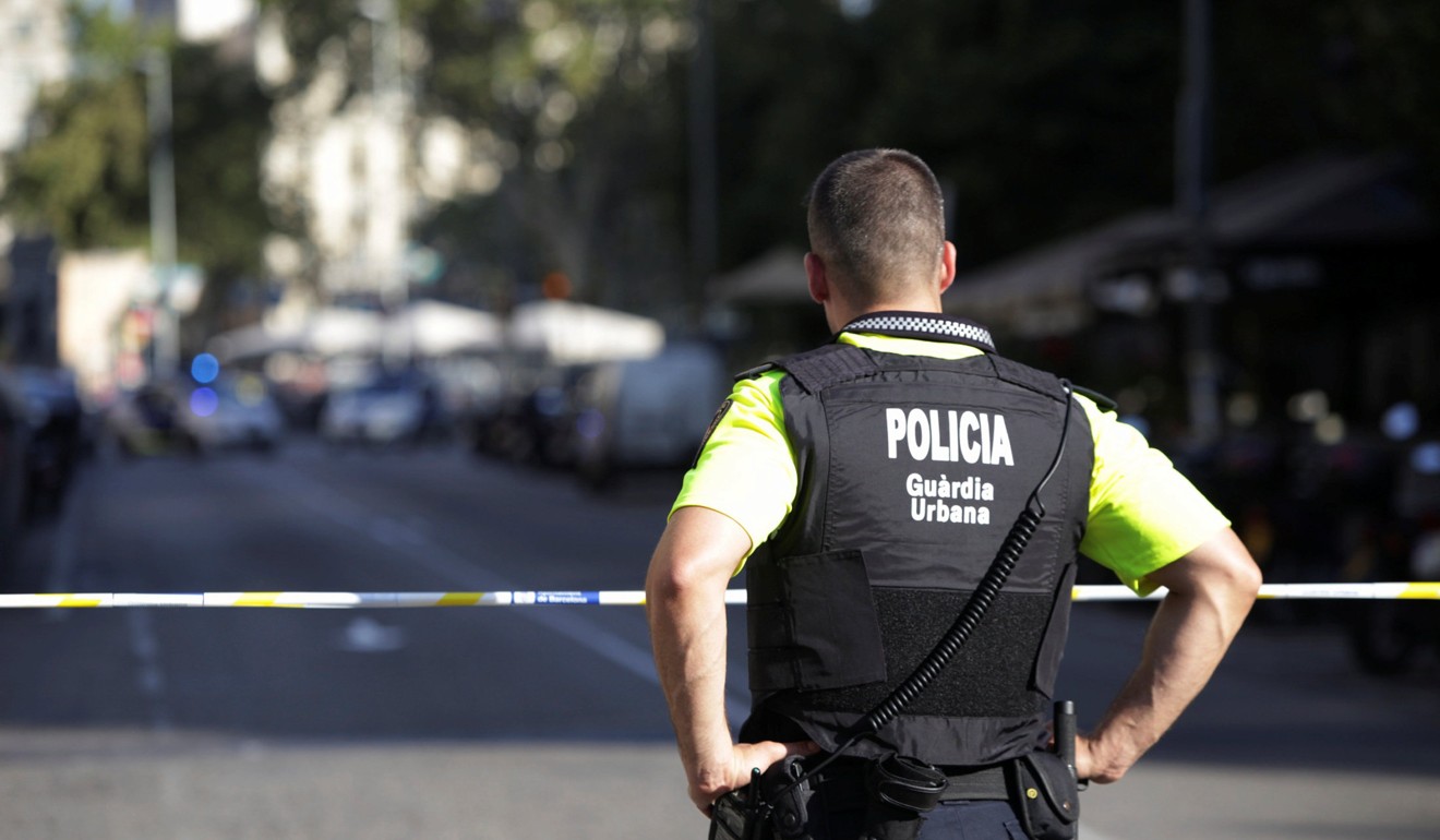 A police officer stands by a cordoned off street after a van crashed into pedestrians near the Las Ramblas avenue in central Barcelona. Photo: Reuters