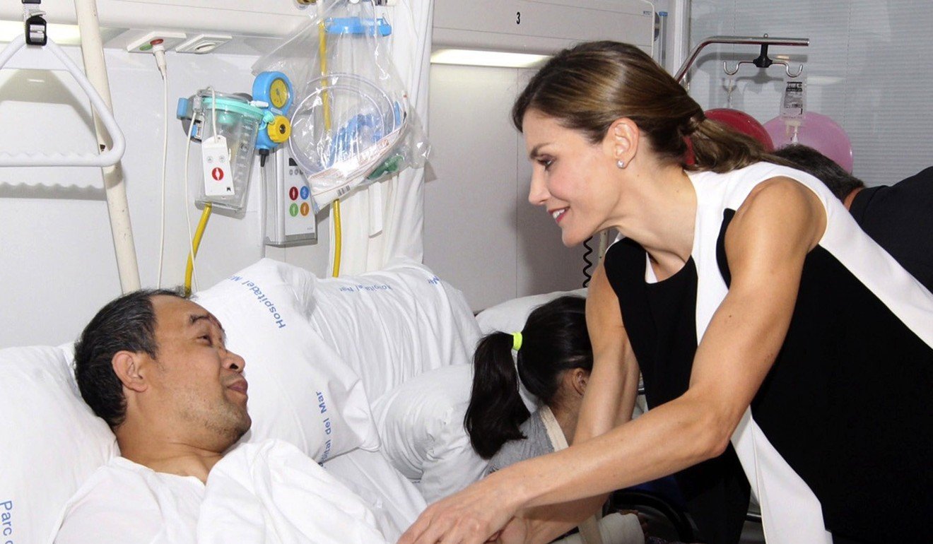 Spain's Queen Letizia greets a man during her visit to victims of the terrorist attacks at the Hospital del Mar, in Barcelona. Photo: EPA