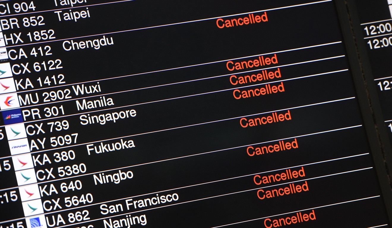 A display board showing flights cancelled due to Typhoon Hato at the downtown airport check-in station in Hong Kong's Central district on August 23, 2017. Photo: AFP