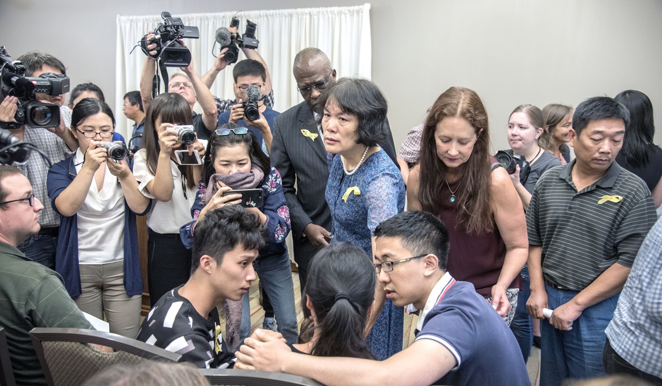 Members of Zhang’s family (seated) at the press briefing in Illinois. Photo: Associated Press
