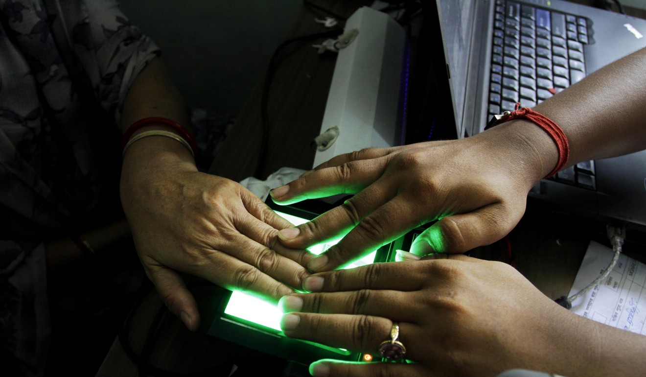 An operator helps an elderly woman scan her fingerprints as she enrols for Aadhar, India's unique identification project in Calcutta, India. File photo: AP