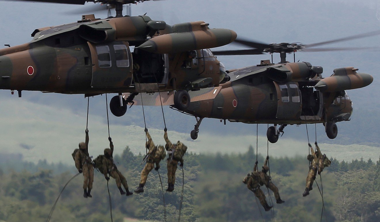 Japanese soldiers rappel from UH-60 Black Hawk helicopters. Photo: Reuters
