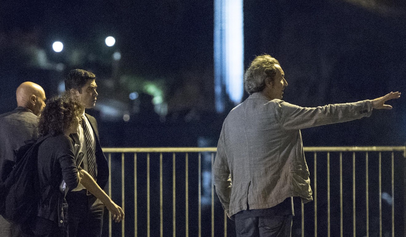 Sorrentino (right) on set with Scamarcio (third left). Photo: EPA