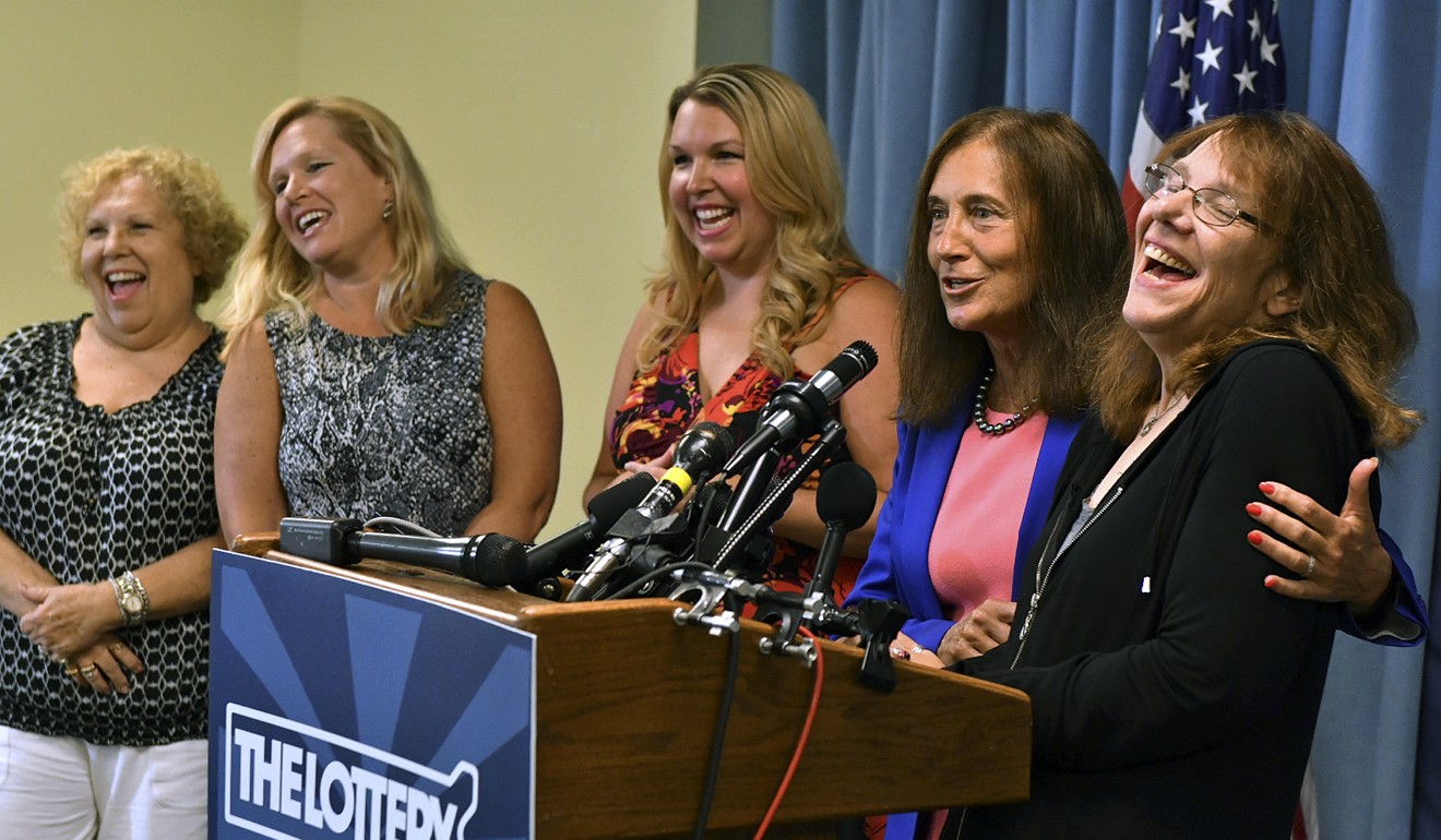 Mavis Wanczyk, right, of Chicopee, Massachusetts, laughs beside state treasurer Deb Goldberg during a news conference where she claimed the $758.7 million Powerball prize at Massachusetts State Lottery headquarters, on Thursday. At left are Wancyk's mother and two sisters. Photo: AP