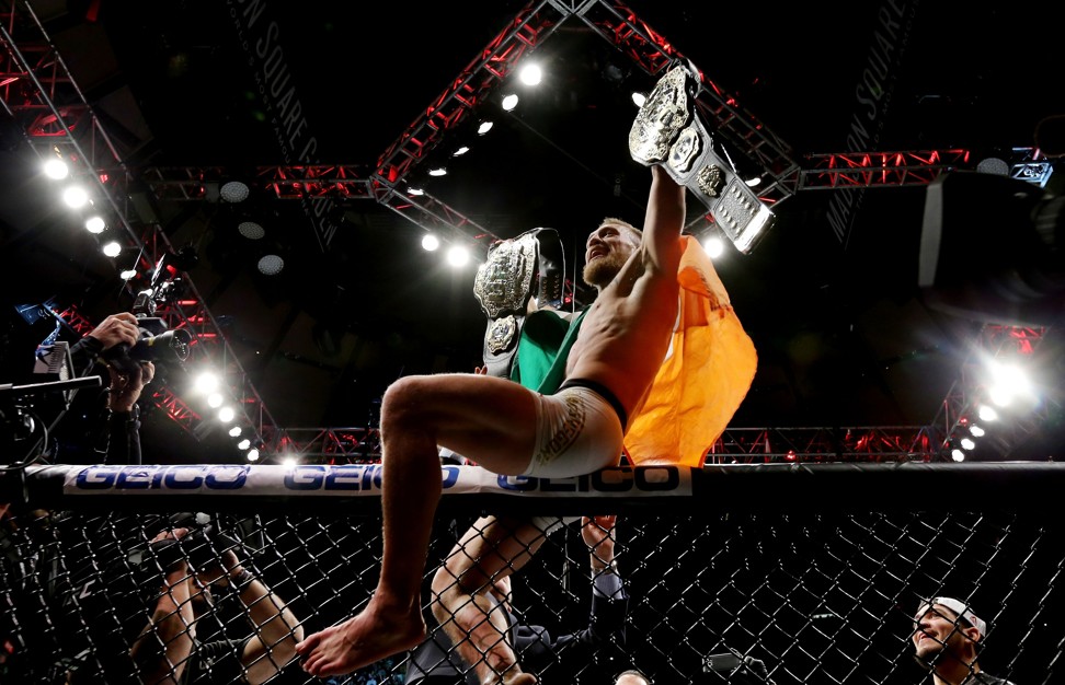 McGregor made history by becoming a champion in two different weight divisions simultaneously in his win over Eddie Alvarez. Photo: AFP