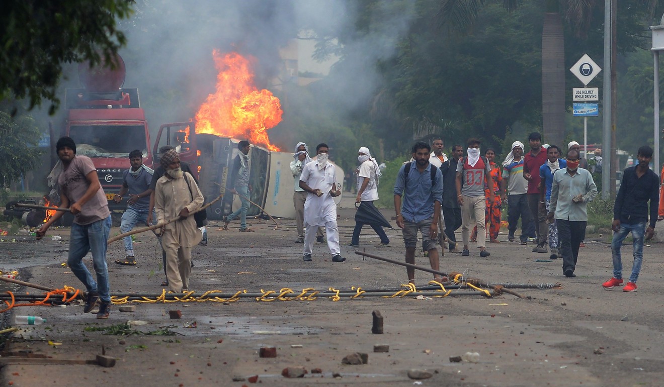 Supporters of guru Ram Rahim Singh clash with security forces in Panchkula. Photo: AFP