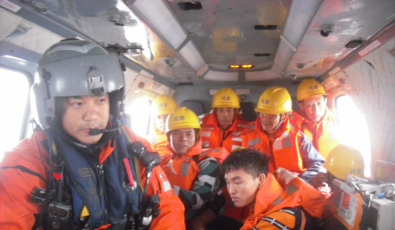 Government Flying Service staff aboard a helicopter on Sunday. Photo: Handout