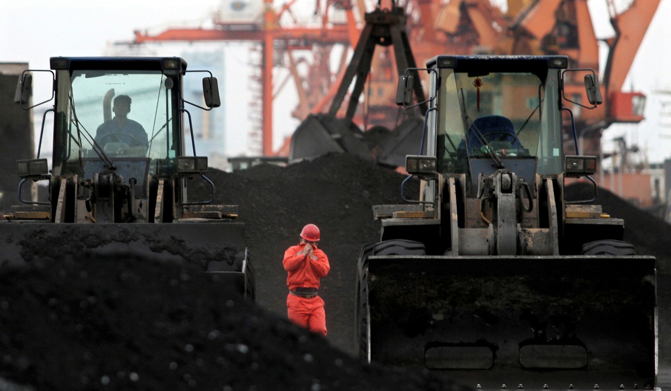 Front-end loaders being used to move coal at Dandong port in the Chinese border city of Dandong. Photo: Reuters
