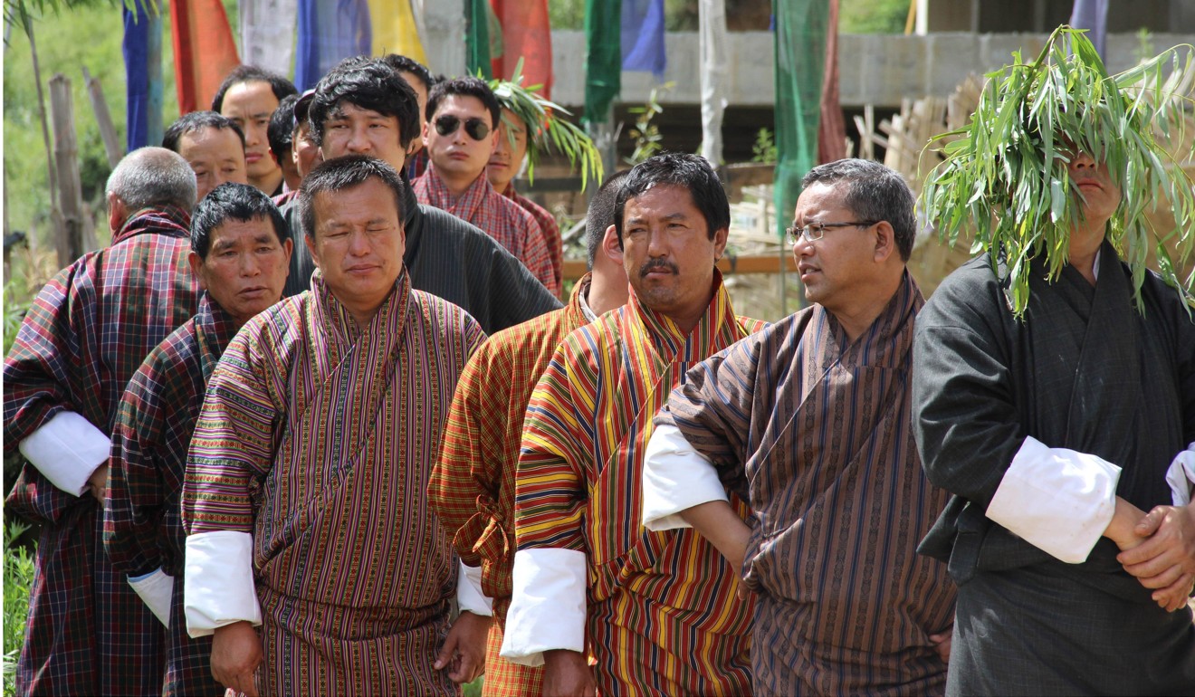 Bhutanese men wait in line to cast their votes at a polling station in Bhutan’s capital, Thimphu, in July 2013. Photo: AFP