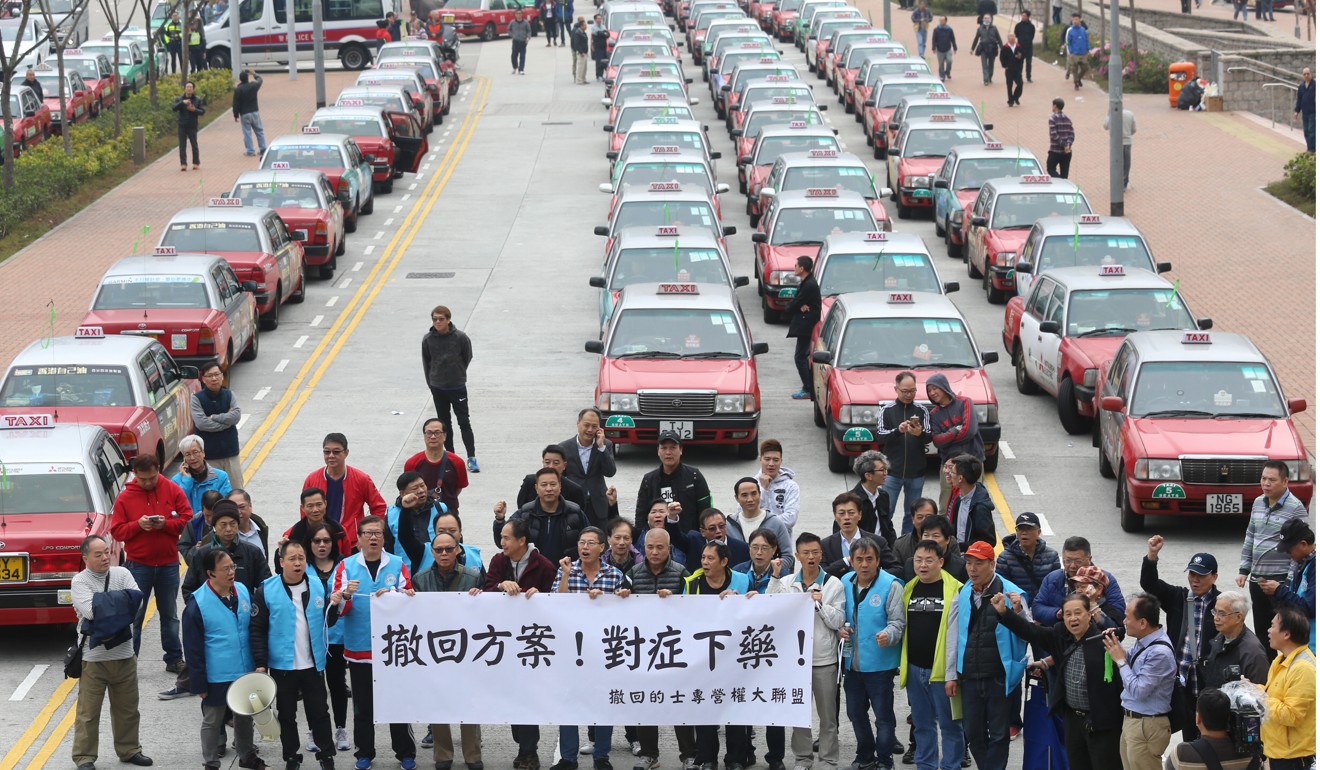 Taxi drivers stage a demonstration near the government headquarters in March this year to protest against a proposal to introduce a premium service. With the protection of taxi drivers and crackdowns on Uber drivers, there is no incentive for Hong Kong taxi drivers to improve their service. Photo: Dickson Lee