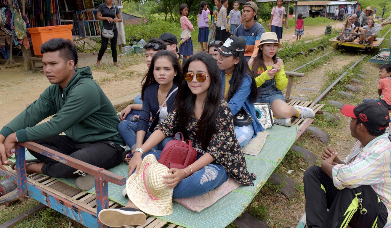 Tourists aboard the Bamboo Train. Photo: AFP