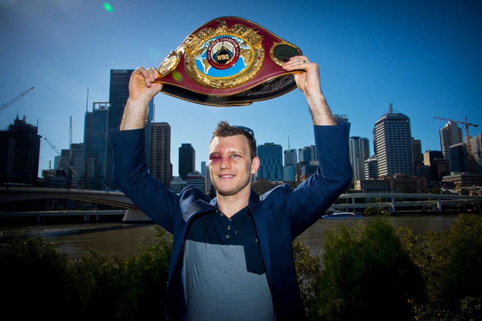 A battered Horn raises his WBO title belt. Photo: AFP