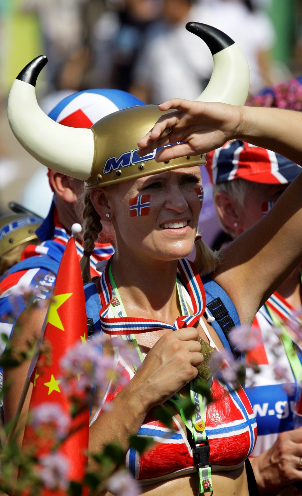 A fan from Norway watches the Mountain Bike Women's Cross Country Cycling event, at the Beijing 2008 Olympics. Photo: AP
