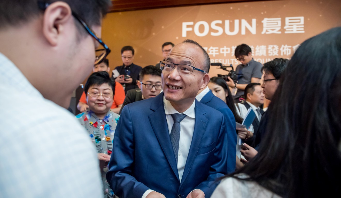 Billionaire Guo Guangchang, chairman and co-founder of Fosun International Ltd. (C) speaks with members of the media following a news conference in Hong Kong at the end of August. Photo: Bloomberg