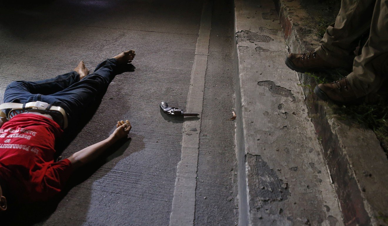 A home-made pistol is seen next to the body of a man who was killed in a gun battle last month. The man was one of many people who have fallen victim to President Rodrigo Duterte’s war on drugs. Photo: AP